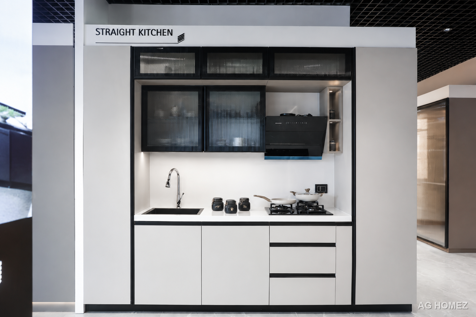 Straight kitchen display at the AG Homez Experience Centre with fluted glass cabinets and built-in hob